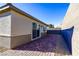 Backyard view featuring a brick patio, desert landscaping, and privacy wall at 9428 Noble Fir Ridge Ave, Las Vegas, NV 89143