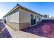 Backyard view featuring a brick patio and desert landscaping at 9428 Noble Fir Ridge Ave, Las Vegas, NV 89143