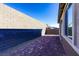 Backyard view featuring a brick patio and privacy wall at 9428 Noble Fir Ridge Ave, Las Vegas, NV 89143