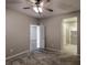 Bedroom featuring soft carpet, a ceiling fan, and ensuite bathroom and walk-in closet view at 9428 Noble Fir Ridge Ave, Las Vegas, NV 89143