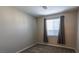 This bedroom has carpeting and a large window at 9428 Noble Fir Ridge Ave, Las Vegas, NV 89143