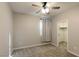 This cozy bedroom features neutral carpeting and a ceiling fan at 9428 Noble Fir Ridge Ave, Las Vegas, NV 89143
