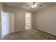 Bright bedroom featuring soft carpet, a ceiling fan, and an ensuite bathroom view at 9428 Noble Fir Ridge Ave, Las Vegas, NV 89143