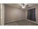 This bedroom has carpeting and a large window at 9428 Noble Fir Ridge Ave, Las Vegas, NV 89143