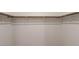 Walk-in closet has white walls and ample space to hang items at 9428 Noble Fir Ridge Ave, Las Vegas, NV 89143