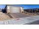 This single Gathering home boasts a brick driveway, neutral color palette, and charming desert landscaping at 9428 Noble Fir Ridge Ave, Las Vegas, NV 89143
