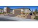 Beautiful single-story home showcasing a brick driveway, two-car garage, and desert landscaping at 9428 Noble Fir Ridge Ave, Las Vegas, NV 89143