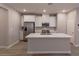 This modern kitchen features white cabinets, stainless steel appliances, and a large center island at 9428 Noble Fir Ridge Ave, Las Vegas, NV 89143
