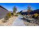 Wide sidewalk showcasing the meticulously maintained landscaping and native vegetation in the community at 9428 Noble Fir Ridge Ave, Las Vegas, NV 89143