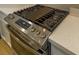 Stainless steel stove with griddle and digital interface atop bright countertops offers modern cooking at 9428 Noble Fir Ridge Ave, Las Vegas, NV 89143