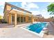 A sparkling pool and covered patio enhance the appeal of this landscaped backyard at 9519 Wild Valley Ave, Las Vegas, NV 89148