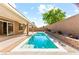 The backyard features a shimmering pool, covered patio, and verdant landscaping at 9519 Wild Valley Ave, Las Vegas, NV 89148