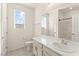 Bright bathroom featuring a white vanity, toilet, and a large mirror reflecting natural light at 9519 Wild Valley Ave, Las Vegas, NV 89148