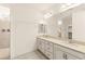 Well-lit bathroom with double sinks, granite counters, a large mirror, and tiled walk-in shower at 9519 Wild Valley Ave, Las Vegas, NV 89148