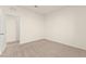 This bedroom features neutral carpet, baseboards, and paint and an open doorway at 9519 Wild Valley Ave, Las Vegas, NV 89148