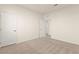 This bedroom features neutral carpet, baseboards, and paint and an open doorway at 9519 Wild Valley Ave, Las Vegas, NV 89148