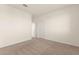 A bright bedroom featuring neutral carpet, baseboards and paint, and two doors at 9519 Wild Valley Ave, Las Vegas, NV 89148