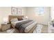 A comfortably staged bedroom featuring neutral decor, a window with a view, and soft, cozy textiles at 9519 Wild Valley Ave, Las Vegas, NV 89148