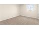 This bedroom features a window with blinds and neutral carpet, baseboards, and paint at 9519 Wild Valley Ave, Las Vegas, NV 89148