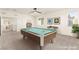 Spacious game room with a pool table, natural light, and ample space for entertainment at 9519 Wild Valley Ave, Las Vegas, NV 89148