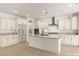 A bright kitchen boasts white cabinets, stainless steel appliances, and a large center island at 9519 Wild Valley Ave, Las Vegas, NV 89148
