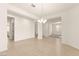 Open living area with wood floors, modern lighting, and access to other rooms at 9519 Wild Valley Ave, Las Vegas, NV 89148