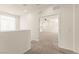 Carpeted loft area with an open view of the adjacent living area and natural light at 9519 Wild Valley Ave, Las Vegas, NV 89148