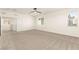 Open carpeted loft featuring natural light and a view of an adjacent living area at 9519 Wild Valley Ave, Las Vegas, NV 89148