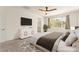 Comfortable main bedroom showcasing a ceiling fan, ensuite bath access, and window view at 9519 Wild Valley Ave, Las Vegas, NV 89148