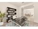 Home office featuring a modern desk, shelving, and a view to a dining room in the background at 9519 Wild Valley Ave, Las Vegas, NV 89148