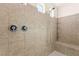 A close-up view of the tiled walk-in shower with dual shower heads and built-in bench at 9519 Wild Valley Ave, Las Vegas, NV 89148