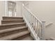 Carpeted staircase with white railing leading to the upper level of the home at 9519 Wild Valley Ave, Las Vegas, NV 89148
