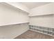 Large walk-in closet with built in shelving and neutral carpeting at 9519 Wild Valley Ave, Las Vegas, NV 89148