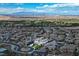 Expansive aerial view of a residential neighborhood with well-manicured lawns and a distant mountain range at 10 Olympia Outlook Dr, Las Vegas, NV 89141