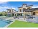 Spacious backyard showcasing a pool, outdoor kitchen, and patio area perfect for entertaining guests at 10 Olympia Outlook Dr, Las Vegas, NV 89141