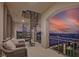A covered balcony offers an elegant spiral staircase and stunning city views at sunset, providing a serene retreat at 10 Olympia Outlook Dr, Las Vegas, NV 89141
