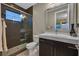 A modern bathroom featuring a glass-enclosed shower, dark vanity, and contemporary fixtures for a sleek design at 10 Olympia Outlook Dr, Las Vegas, NV 89141