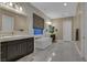 Bright, modern bathroom featuring dual sinks, a soaking tub, and marble tile at 10 Olympia Outlook Dr, Las Vegas, NV 89141