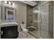 Bathroom features a sleek vanity, modern fixtures, and a glass-enclosed shower with decorative tiling at 10 Olympia Outlook Dr, Las Vegas, NV 89141