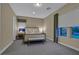 Spacious bedroom with a sitting area, carpeted floors, and two large windows with views of the outside at 10 Olympia Outlook Dr, Las Vegas, NV 89141