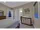 Bedroom with a view to the ensuite bathroom featuring contemporary furniture and neutral decor at 10 Olympia Outlook Dr, Las Vegas, NV 89141