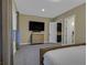 Well-lit primary bedroom suite features a large TV, with an ensuite bath and walk-in closet at 10 Olympia Outlook Dr, Las Vegas, NV 89141