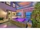 Beautiful courtyard with a relaxing jacuzzi surrounded by lush greenery and outdoor living spaces at 10 Olympia Outlook Dr, Las Vegas, NV 89141