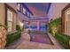 Beautiful courtyard with water feature, manicured greenery, and access to covered outdoor living space at sunset at 10 Olympia Outlook Dr, Las Vegas, NV 89141