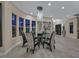 Bright dining room featuring modern chandelier, hardwood floors, and large windows at 10 Olympia Outlook Dr, Las Vegas, NV 89141