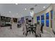 Open dining area featuring a modern chandelier, hardwood floors, with direct access to the kitchen and living room at 10 Olympia Outlook Dr, Las Vegas, NV 89141