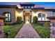 Inviting front entrance with a brick pathway and manicured bushes leading to an inviting doorway and sophisticated design at 10 Olympia Outlook Dr, Las Vegas, NV 89141