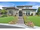 Elegant home boasts a meticulously landscaped front yard and inviting stone and stucco facade at 10 Olympia Outlook Dr, Las Vegas, NV 89141