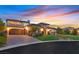 Stunning two-story home features a grand entrance, manicured landscaping, and a three-car garage with a brick driveway at 10 Olympia Outlook Dr, Las Vegas, NV 89141