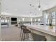 Open-concept game room featuring a wet bar, comfortable seating, and ample natural light at 10 Olympia Outlook Dr, Las Vegas, NV 89141